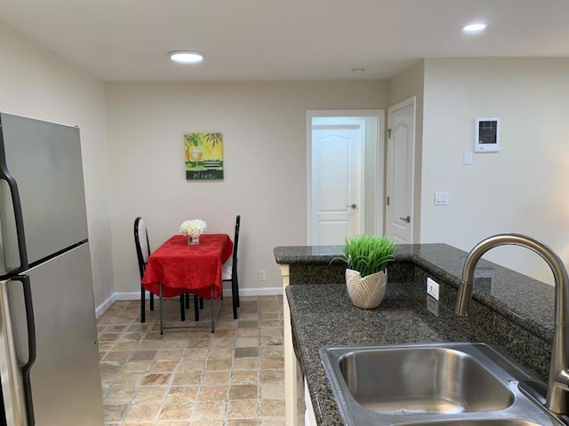 kitchen featuring sink and stainless steel fridge