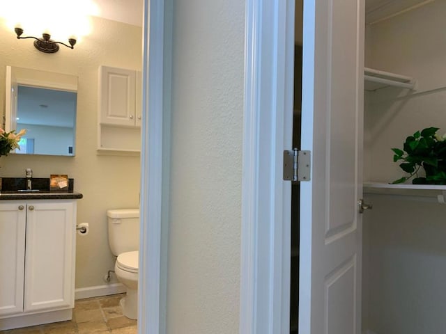 bathroom featuring toilet and vanity