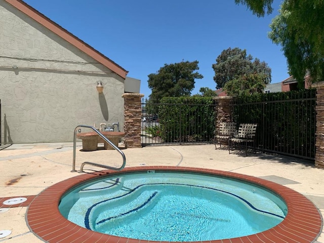 view of pool with a patio area and a community hot tub