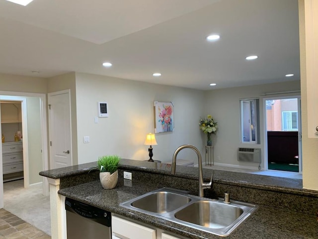 kitchen with sink, stainless steel dishwasher, light carpet, and a wall mounted AC