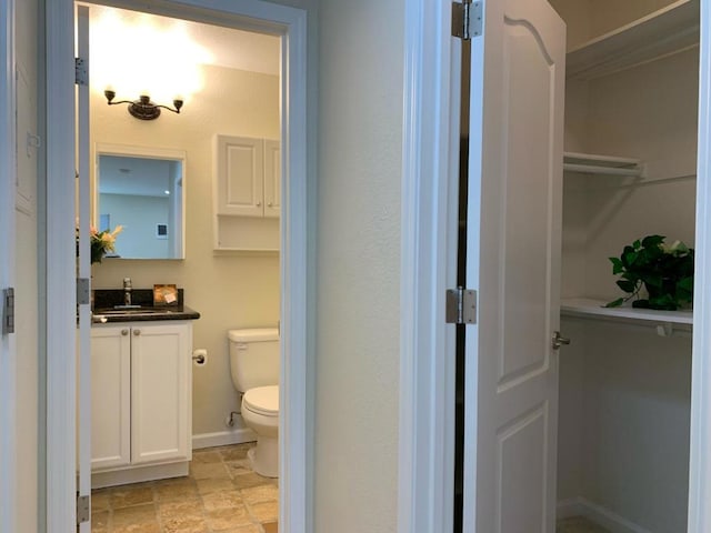 bathroom featuring toilet and vanity