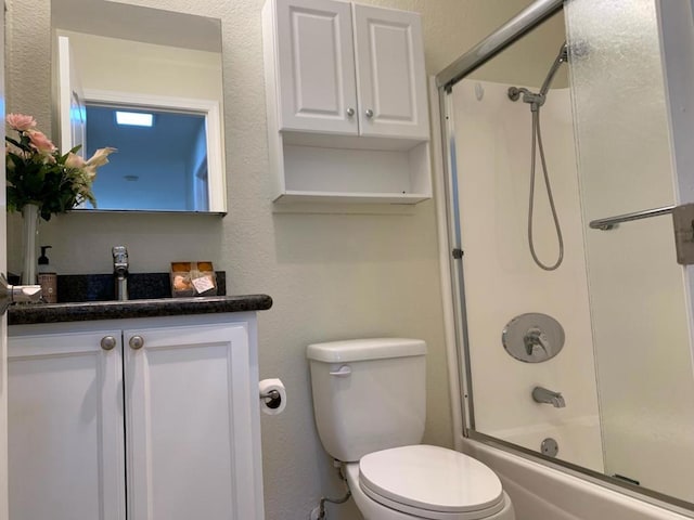 full bathroom featuring toilet, vanity, and shower / bath combination with glass door