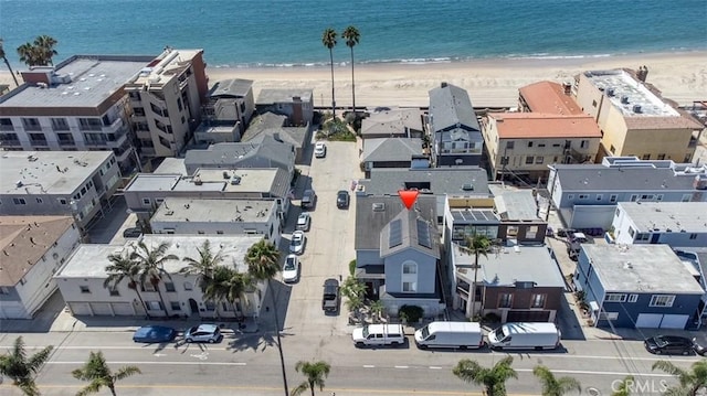 aerial view with a water view and a beach view