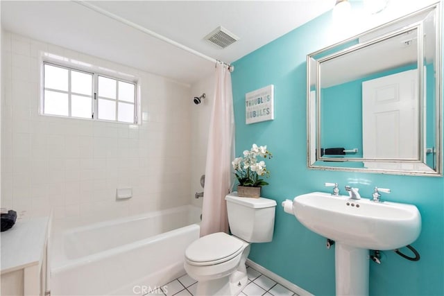 bathroom featuring tile patterned floors, toilet, and shower / bath combination with curtain