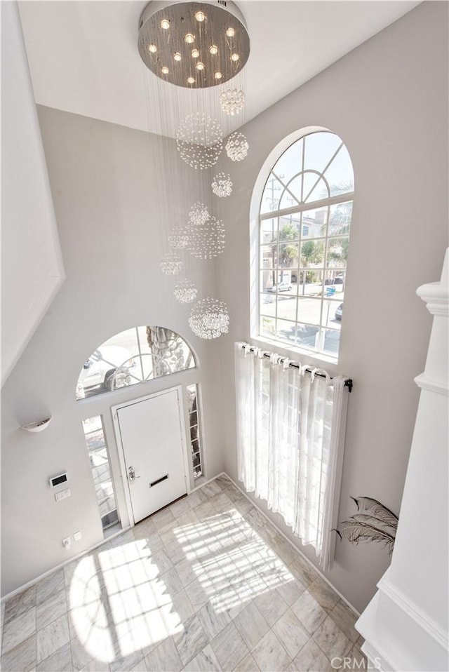 entryway featuring an inviting chandelier