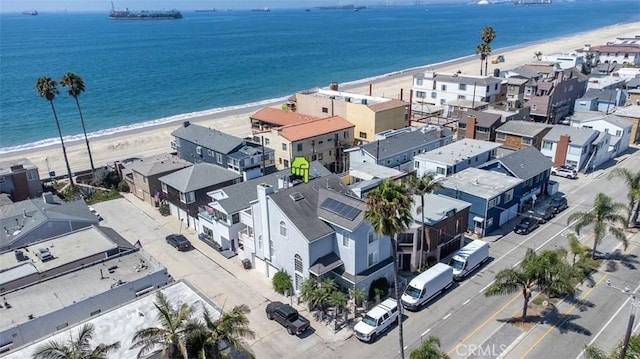 drone / aerial view featuring a water view and a view of the beach