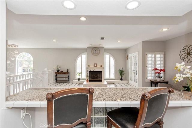 kitchen featuring a breakfast bar area and a fireplace