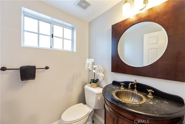 bathroom featuring toilet and vanity