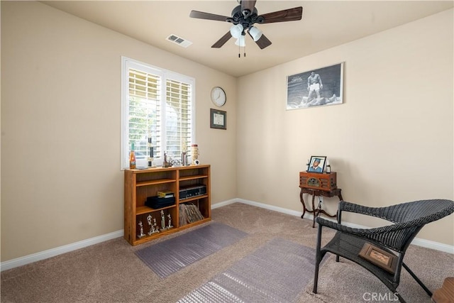 living area with ceiling fan and carpet floors