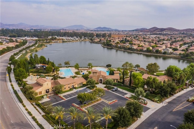 birds eye view of property with a water and mountain view