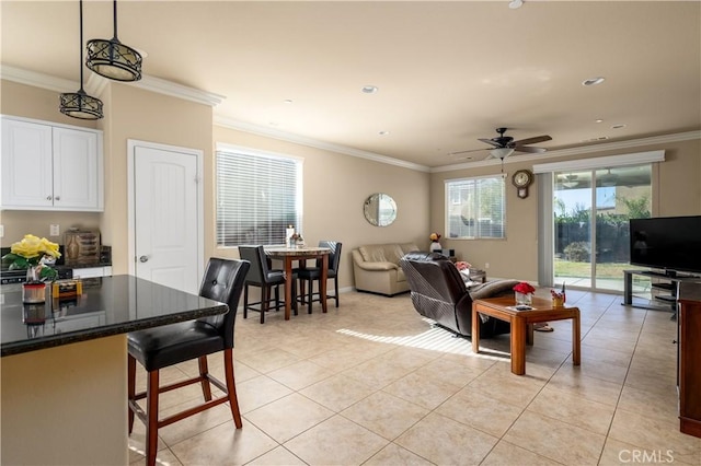 living room with ceiling fan, light tile patterned floors, and crown molding