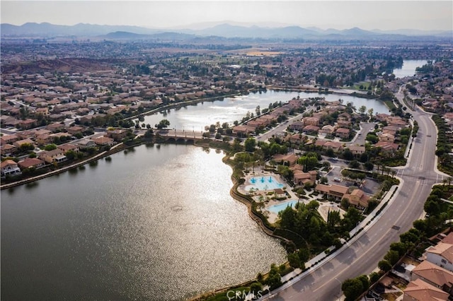 drone / aerial view with a water and mountain view