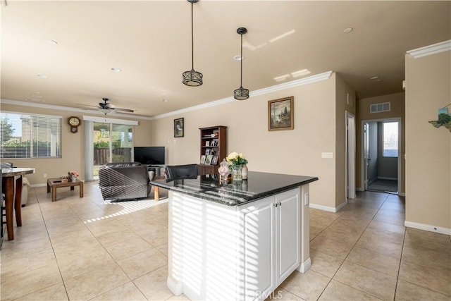 kitchen featuring hanging light fixtures, white cabinets, ceiling fan, and light tile patterned flooring