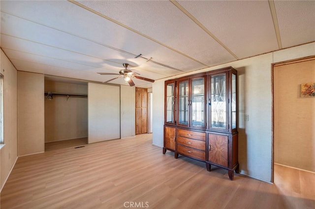 unfurnished bedroom featuring ceiling fan and light wood-type flooring