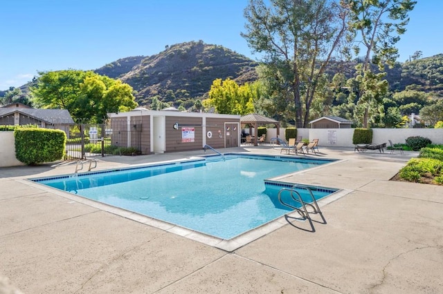 view of pool featuring a patio, a gazebo, and a mountain view