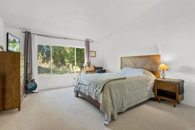 bedroom featuring lofted ceiling and light colored carpet