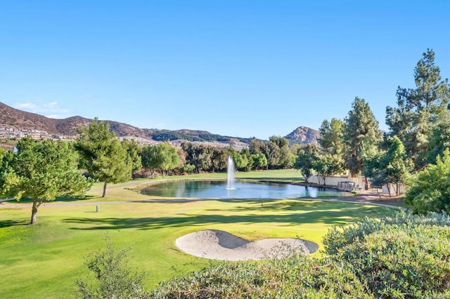 surrounding community with a yard and a water and mountain view