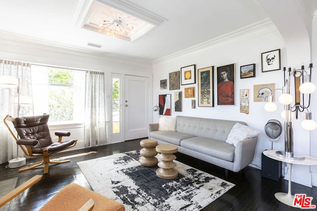 living room featuring dark hardwood / wood-style flooring and ornamental molding