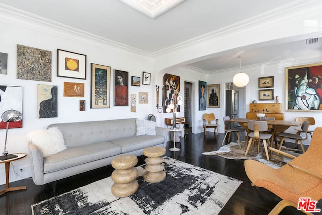 living room with dark wood-type flooring and ornamental molding