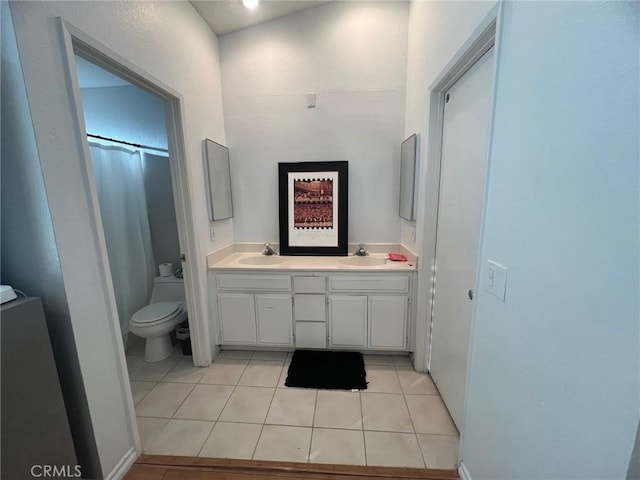 bathroom with tile patterned floors, vanity, and toilet