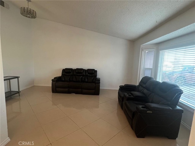 living room with light tile patterned flooring and a textured ceiling