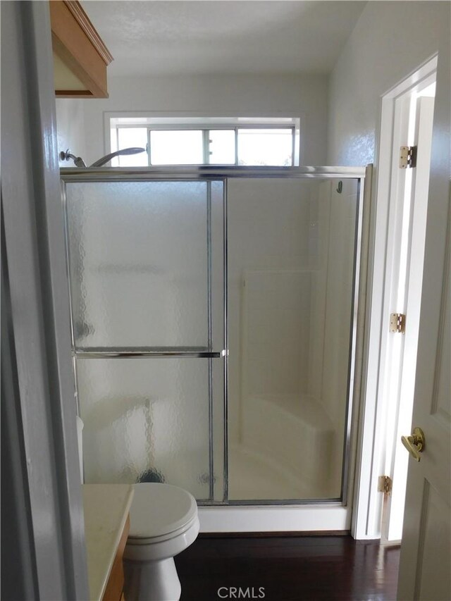 bathroom featuring toilet and walk in shower