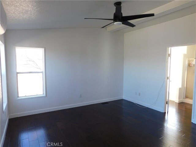 empty room with ceiling fan, a textured ceiling, and dark hardwood / wood-style flooring