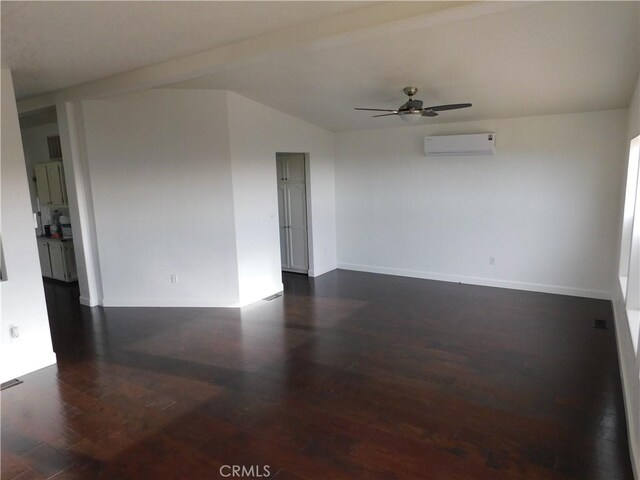 empty room featuring ceiling fan, dark hardwood / wood-style floors, and a wall mounted AC