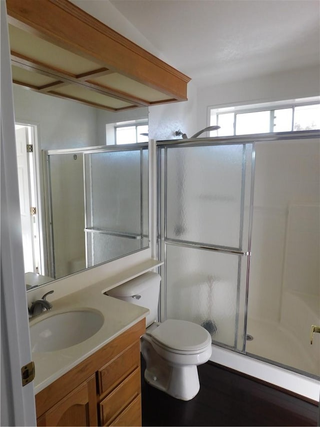 bathroom featuring walk in shower, vanity, and toilet