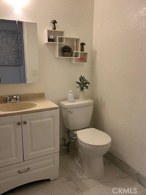 bathroom with toilet and vanity