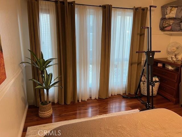 bedroom with dark wood-type flooring