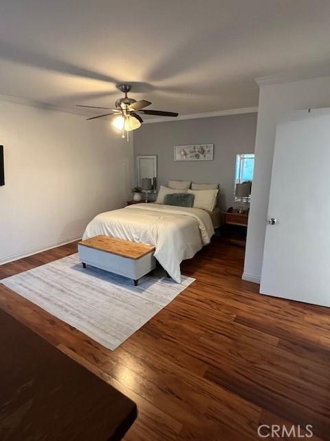 bedroom with ceiling fan, dark hardwood / wood-style flooring, and crown molding