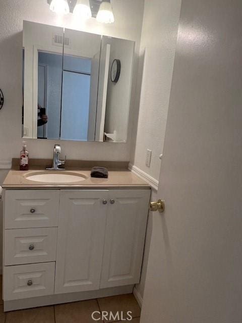 bathroom with vanity and tile patterned flooring