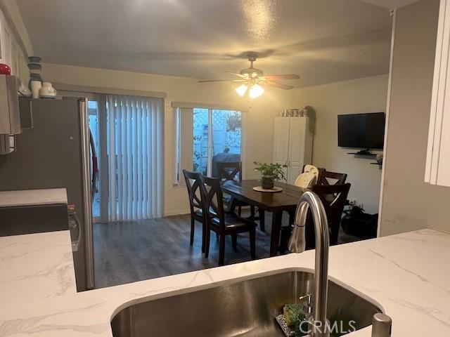 dining space featuring ceiling fan and sink