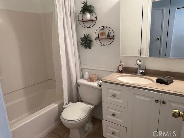 full bathroom with toilet, tile patterned floors, shower / bath combo, and vanity