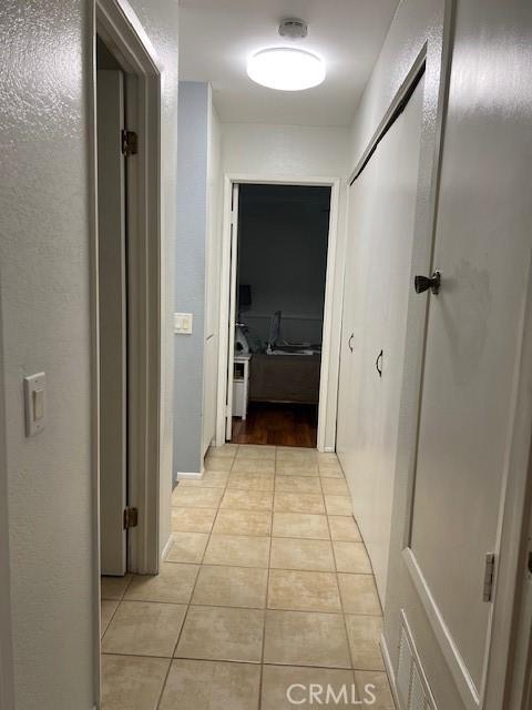 corridor with light tile patterned flooring