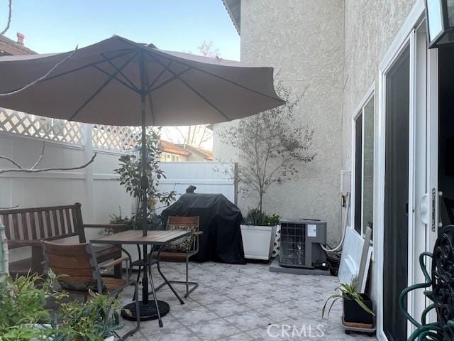 view of patio / terrace with central AC unit and area for grilling