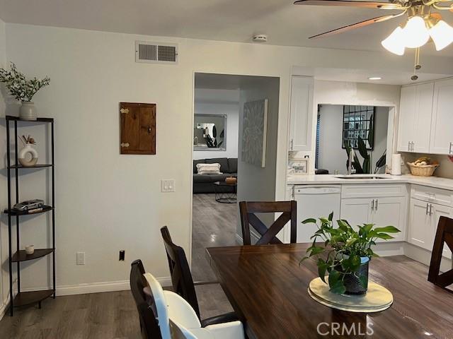 dining area featuring ceiling fan, dark hardwood / wood-style flooring, and sink