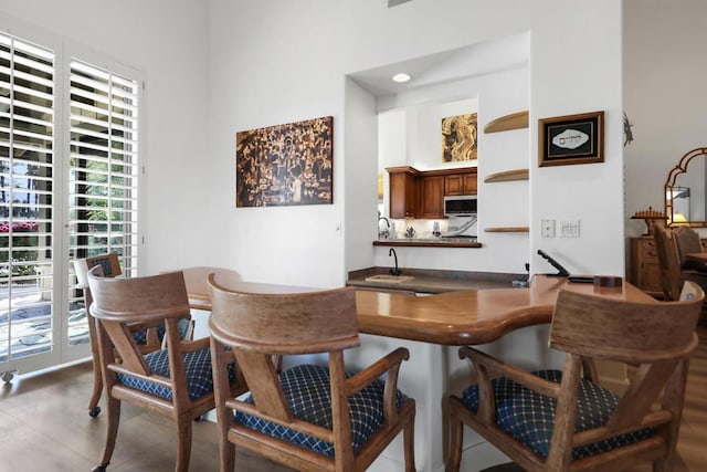 dining space with a towering ceiling and sink