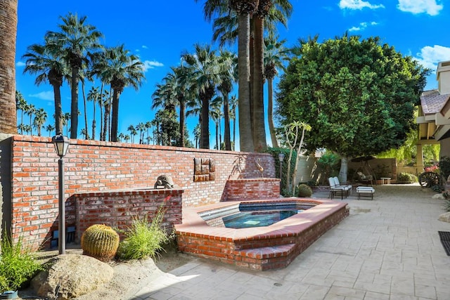 view of patio with an in ground hot tub