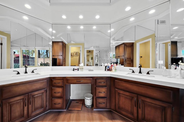 bathroom with hardwood / wood-style floors and vanity