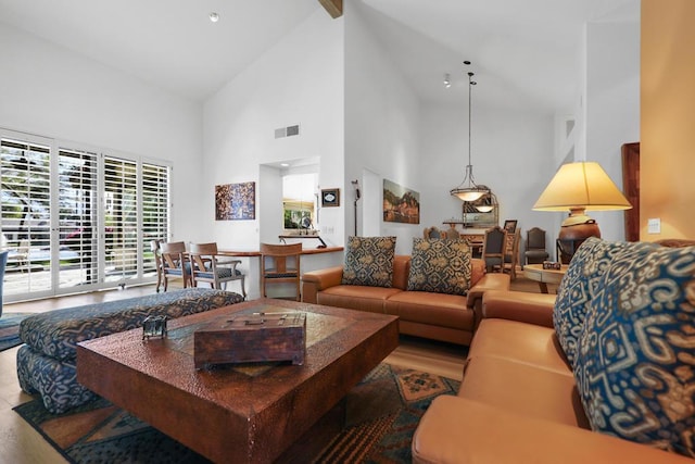 living room featuring high vaulted ceiling, hardwood / wood-style floors, and beam ceiling