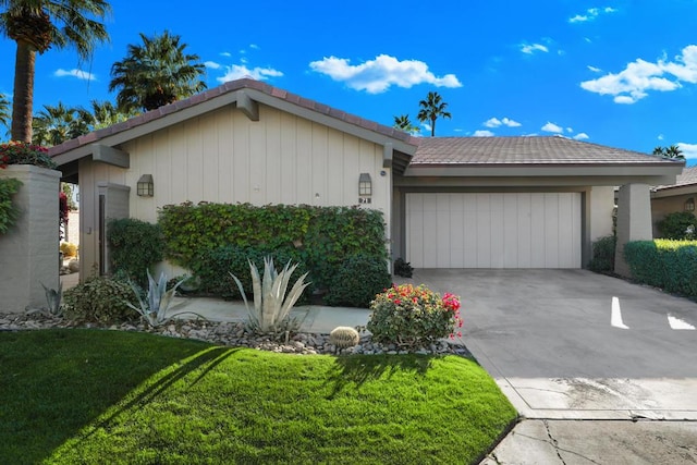 ranch-style house with a garage and a front lawn