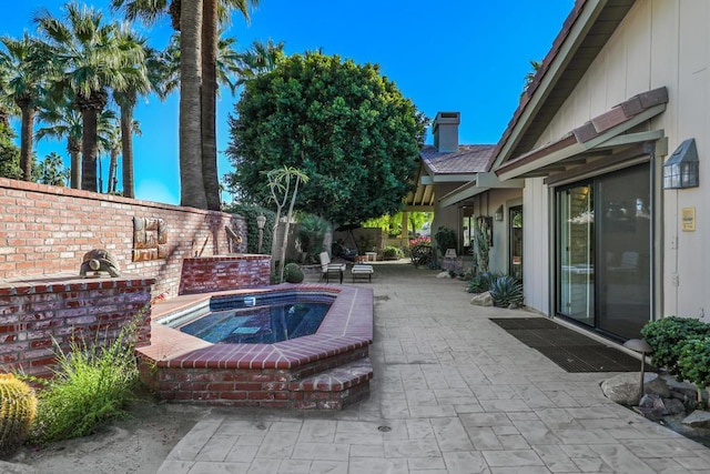 view of swimming pool with an in ground hot tub and a patio area