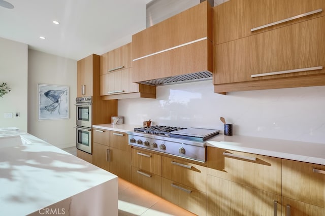 kitchen with light tile patterned floors, premium range hood, and stainless steel appliances