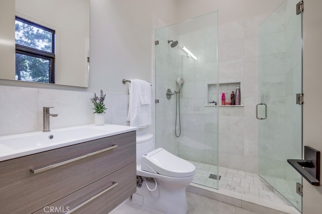 bathroom with toilet, vanity, backsplash, tile patterned flooring, and a shower with door