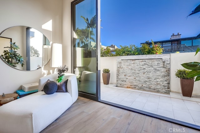 doorway to outside with light wood-type flooring and a wealth of natural light