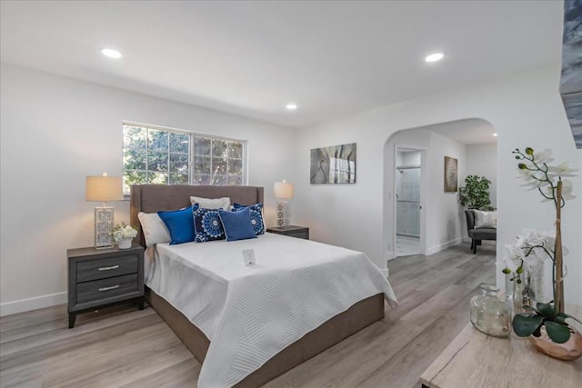 bedroom featuring light hardwood / wood-style floors and ensuite bathroom