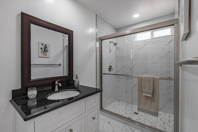 bathroom featuring walk in shower and vanity