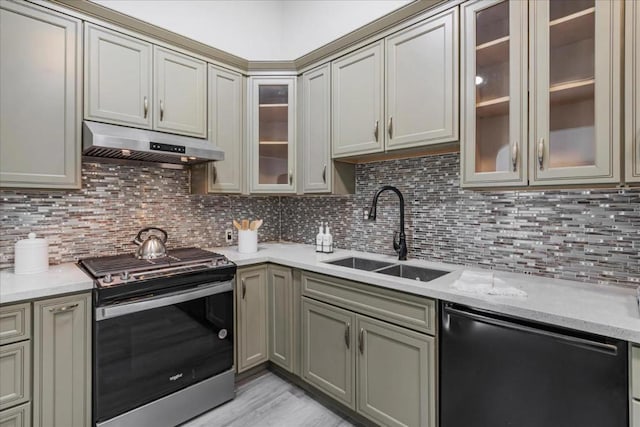 kitchen featuring sink, decorative backsplash, black dishwasher, and stainless steel range with electric cooktop